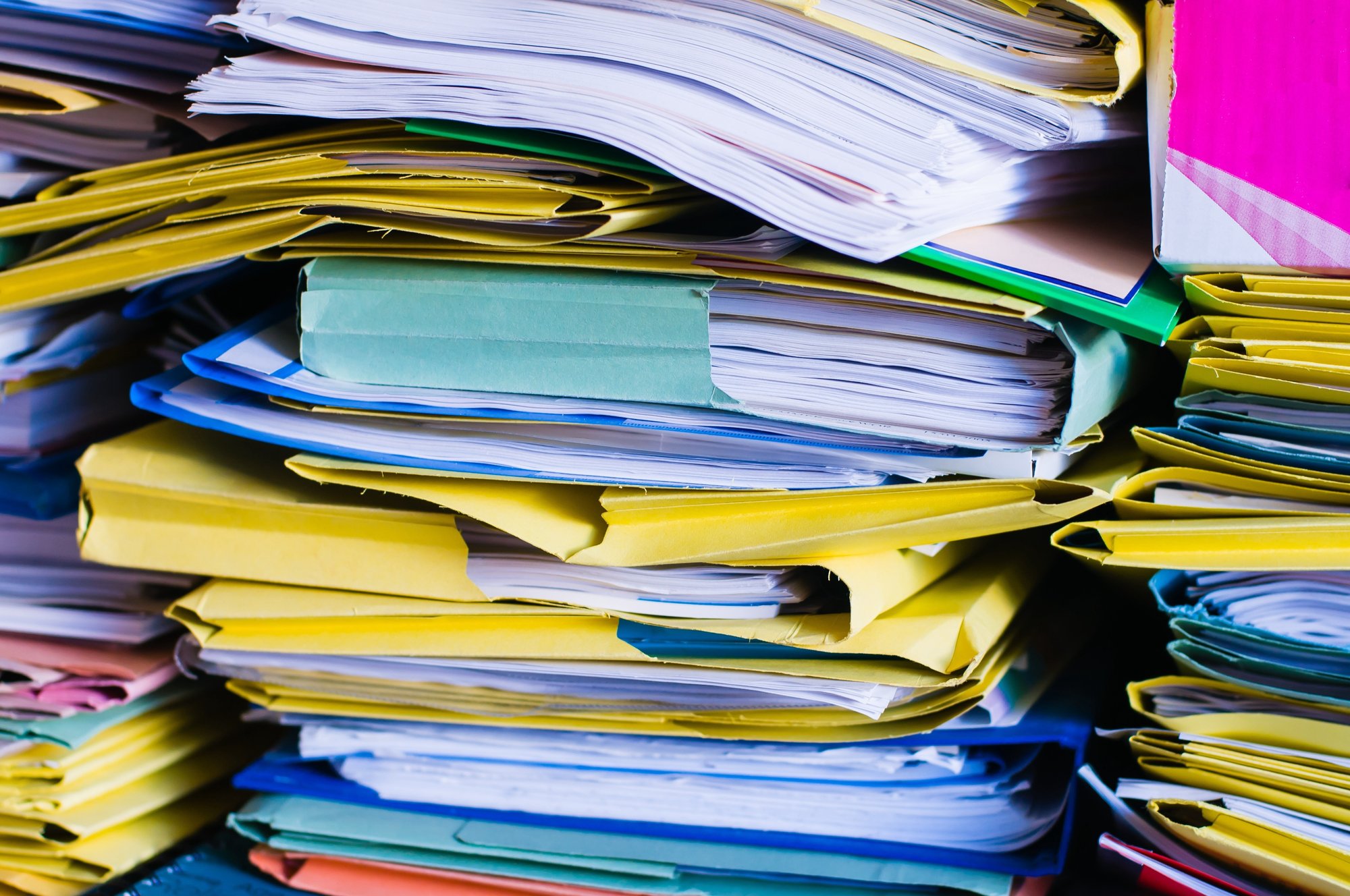 large overwhelming stack of papers and folders