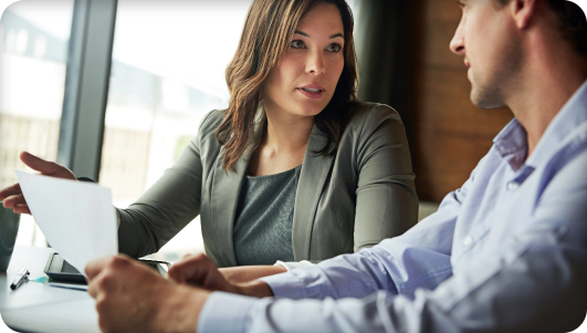 two people discussing record retrieval paperwork two people discussing record retrieval paperwork