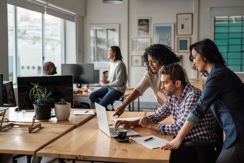 team members working together at a desk team members working together at a desk